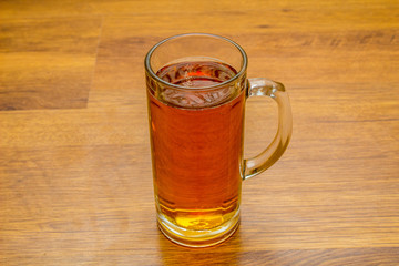 mug of beer on wooden background
