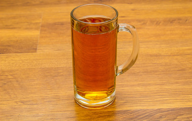 mug of beer on wooden background
