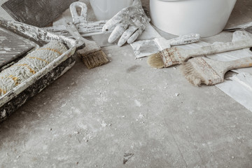 Plastering tools on cement background.