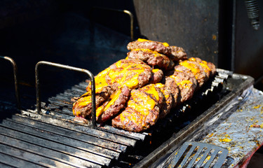 Minced beef with cheese and spices on the grill 