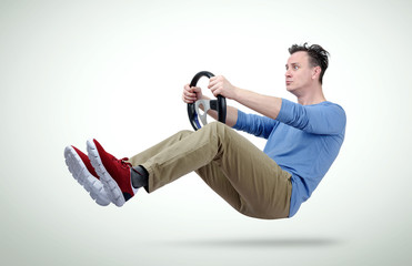 Funny man drives a car with a steering wheel © afxhome