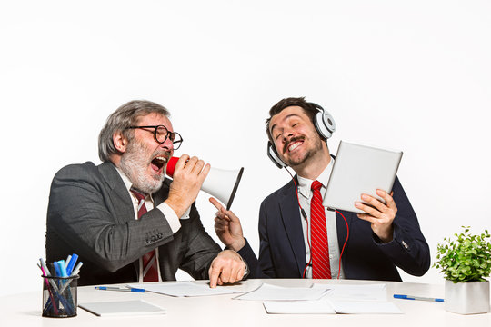 The two colleagues working together at office on white background.