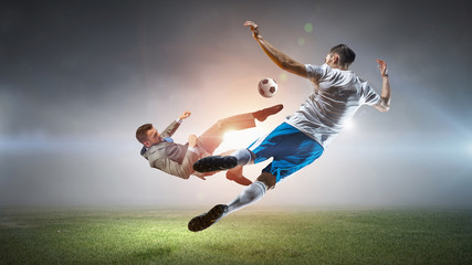 Fototapeta na wymiar Soccer player kicking ball . Mixed media