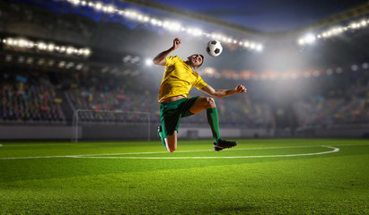 Fototapeta na wymiar Soccer player at sport arena . Mixed media