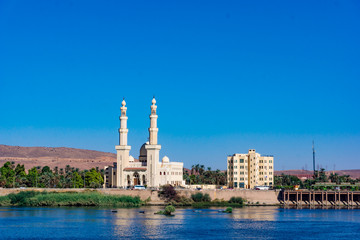 Fototapeta na wymiar The El-Tabia Mosque in Aswan, Egypt. Egyptian Mosque Minarets. Aswan Mosque along the Nile River with two minarets.