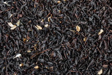 Black tea background. Heap of dry black tea
