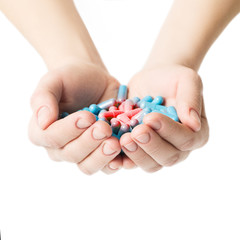 Hands giving capsules from pain