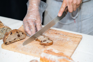 chef slicing bread in th kitchen