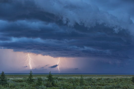 Double lightning strike during a thunderstorm over Hudson bay; Manitoba, Canada
