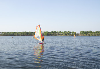 Winsurfing on calm lake
