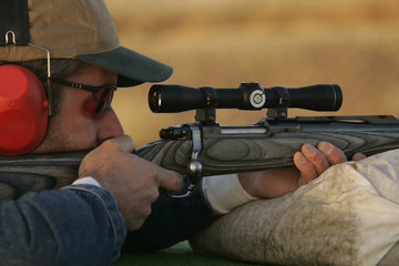 Man Shooting Rifle On Shooting Range