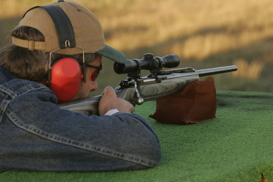 Man Shooting Rifle On Shooting Range