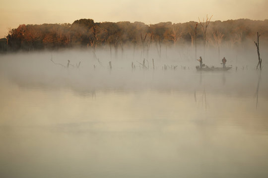 Bass Fishermen Fishing On Lake On A Foggy Morning
