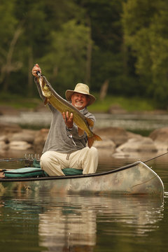 Bass Fishermen In Canoe In A River