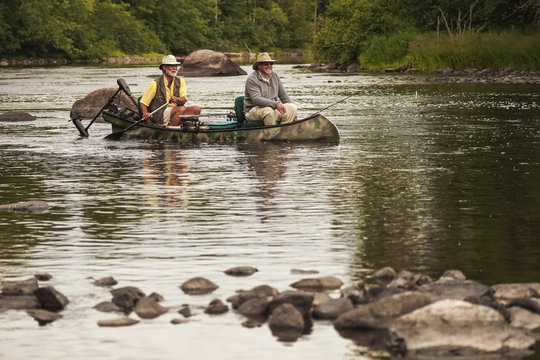 Bass Fishermen In Canoe In A River