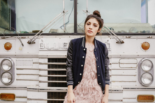 Woman standing against the truck on the beach