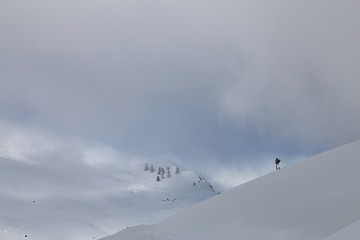 Snow covered landscape with clouds and trees