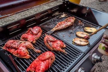 Grilled chicken and fish at street bbq