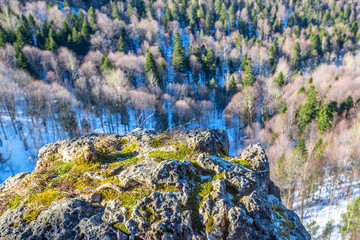 Winter mountains panorama with cliff edge in front