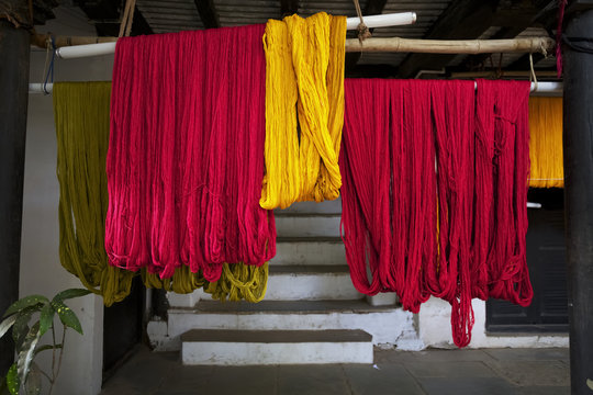 Colourful recently dyed thread hanging out to dry at weavers