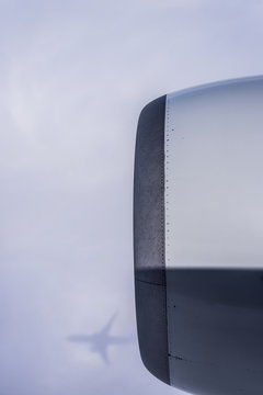 A commercial jet casts a shadow on the clouds; United States of America