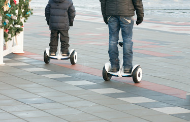 father and son ride on a Segway