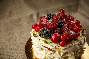 Pavlova, a home made cake from layers of meringue, whipped cream, and fresh berries