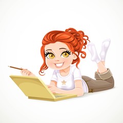 Beautiful redhaired girl lying on a white floor and working at a laptop