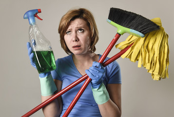 housewife in washing gloves with cleaning spray bottle broom and mop
