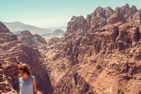 Hipster girl enjoy vacation and journey to Jordan. Gorgeous view from Petra. Negative space for text. Tourism industry. Active lifestyle. Travel concept. Middle East Woman exploring the world