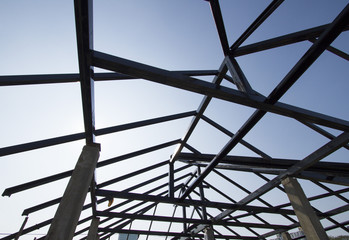 Metal roof structure with blue sky in background