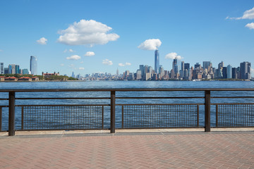New York city skyline view from empty dock terrace in summer, blue sky