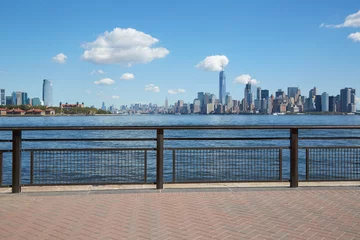Poster New York city skyline view from empty dock terrace in summer, blue sky © andersphoto