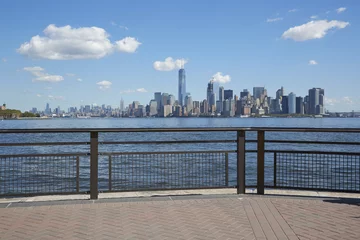 Fotobehang New York city skyline view from empty dock terrace, blue sky © andersphoto