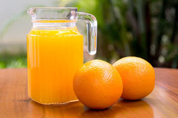 Orange and orange juice on wooden background