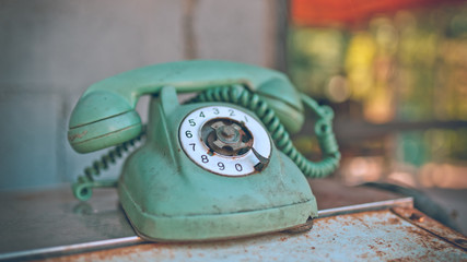 Old rusty grunge rotation phone in vintage style picture.