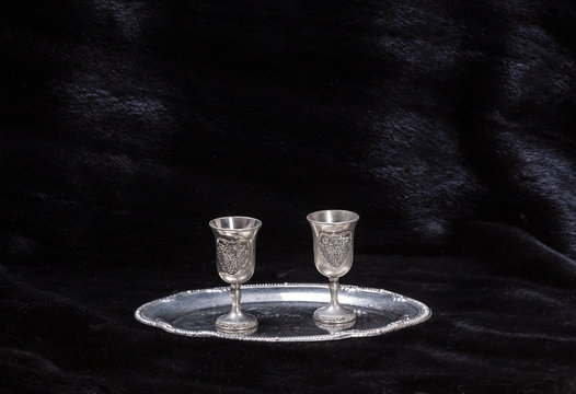 silver glasses for vodka on a black background