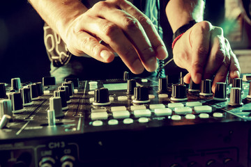DJ playing music at mixer closeup