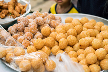 Street food of sweet deep fried grinded cassava with White Sesame Seeds
 and bean stuff. - Akehgss candy.