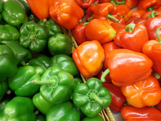 Pile of Vivid Green and Orange Color Ripe Bell-pepper with Stems 