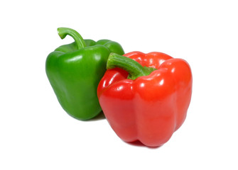 Close-up of two ripe bright color bell peppers, one red and one green with stem isolated on white...