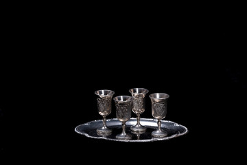 silver glasses for vodka on a black background