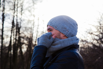 Handsome young man is traveling. He is looking forward in the forest at the nature. Blured...
