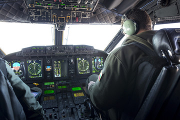 Military carrier airplane cockpit and pilots - obrazy, fototapety, plakaty