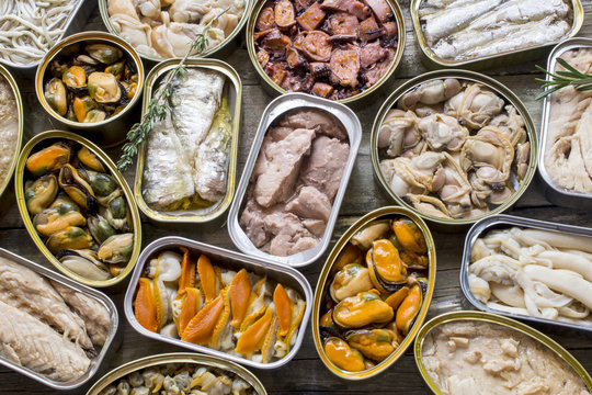 Assortment of cans of canned with different types of fish and seafood