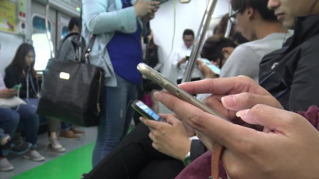 4K Asian woman using smartphone in subway cheack the metro maps of Seoul, as she waits for arrive her stop station in Korea-Dan