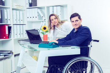 disabled business man and his female colleague