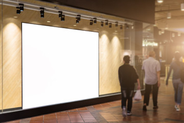 Blank poster in front of store with customers,Blank decoration backdrop for advertising store information.Selective focus on white billboard.