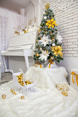 Christmas tree on a white piano