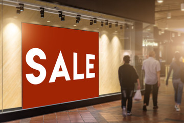 Sale sign in front of shop billboard,Red billboard sign for strike customer eye,Tilt shift selective focus and light flare effect.